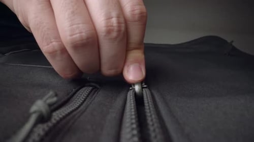 Extreme Close Up Zipper with Hand Unzipping the Sweater Jacket Zipper