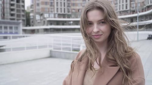 Close-up Portrait of Charming Brunette Brown-eyed Girl Looking at Camera and Smiling. Beautiful