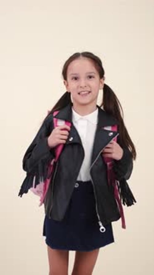Little School Girl with Backpack and Uniform on White Back