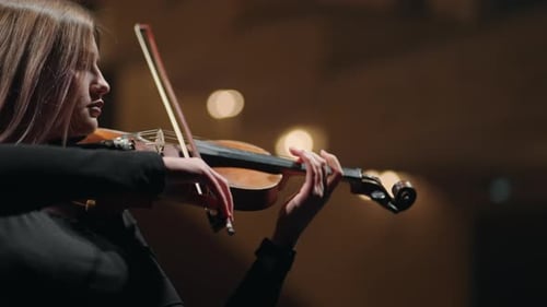 Young Female Violinist is Playing Fiddle on Scene in Opera House or Music Hall Portrait