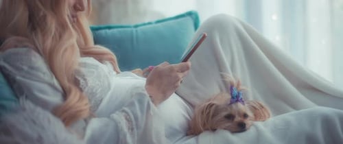Woman with Blonde Hair Using Phone with Dog
