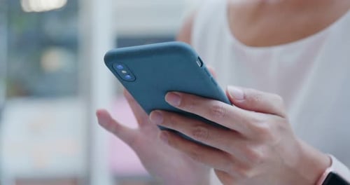 Close Up of Hands Using Blue Smartphone