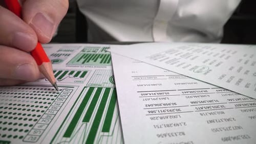 Accountant Analyzing Business Marketing Data on Paper Dashboard at Office Table