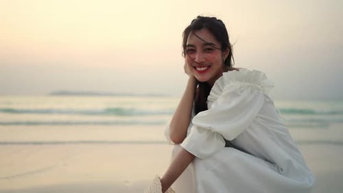 4K Young Asian woman walking on tropical island beach at summer sunset
