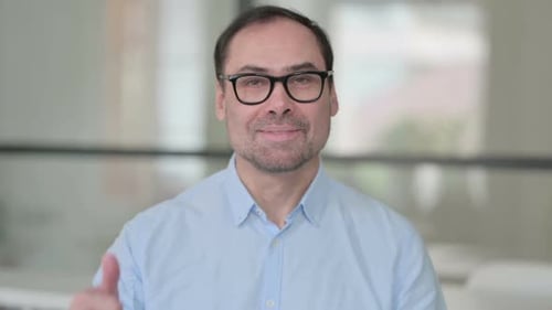 Man Smiling and Giving Thumbs Up Approval