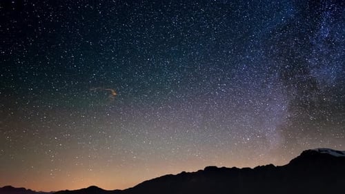 Meteor explosion, meteor shower and stardust smoke trail in night sky, time lapse of the Milky Way