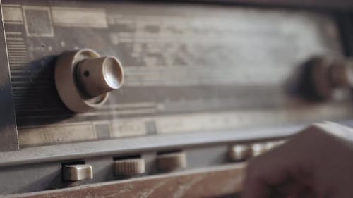 Male Hands Turning an Antiquarian Record Player on