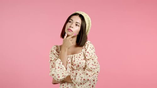 Woman Posing Thoughtfully on Pink Background