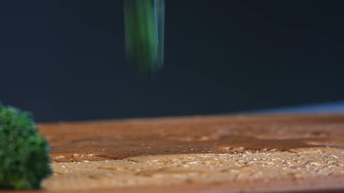Fresh Broccoli Pieces of Green Colour Fall on Cutting Board
