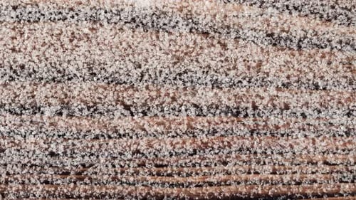 Top view of melting snow on wooden background.