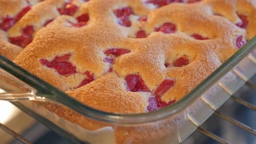 Cherry cake taken from oven close-up 4K 2160p UHD footage - Tasty cherry cake hot taken from oven 4