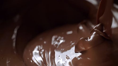 Chocolate Pouring Onto Pool of Melted Chocolate