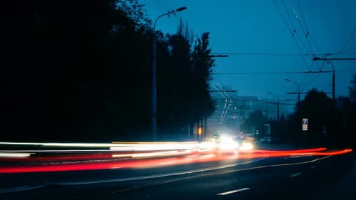 Traffic Streaks Through Urban Night Time Lapse
