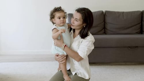 Loving Mother Interacts with Baby at Home