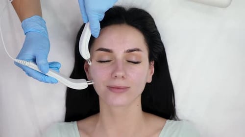 Woman Receiving Facial Beauty Treatment