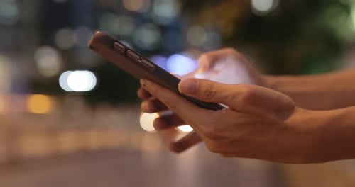 Closeup of woman hands typing on cellphone