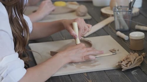 Close-up of a Master Potter, Clay Cutting Special Tool. Female Artist Cutting with a Wooden Loop