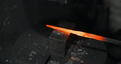 Blacksmith Uses a Hydraulic Hammer to Forge Hot Metal in His Workshop Automatic Hammer is Shaping