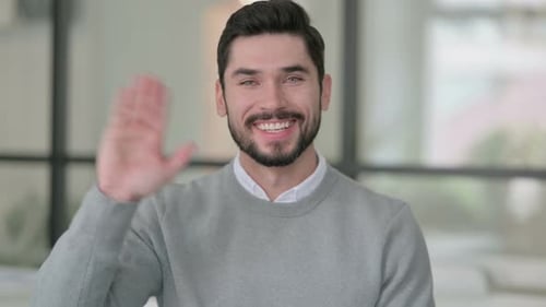 Portrait of Young Man Waving Welcoming