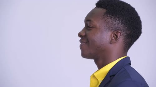 Closeup Profile View of Young Happy African Businessman Smiling