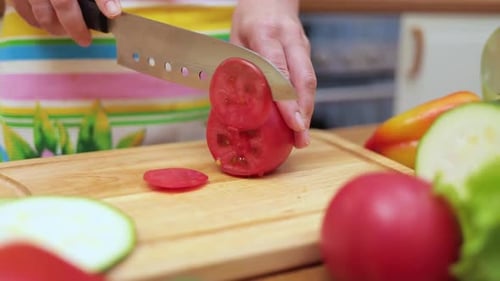 Woman Cutting Fresh Vegetables in Bright Kitchen