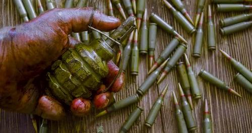 War Death and Suicide the Bloodied Hand of a Soldier or Rebel with a Grenade Against the Background