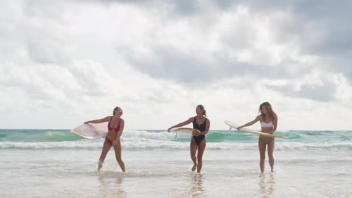 4K Group of Asian woman holding surfboard walking together on the beach in sunny day.