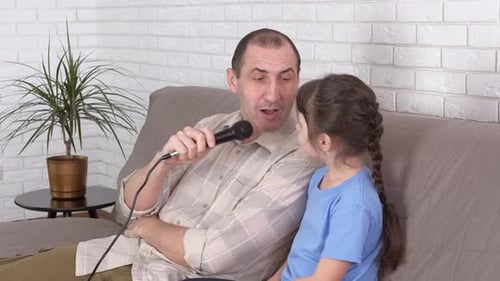 Father and Daughter Singing Together at Home