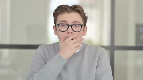 Young Man Reacting with Shock and Surprise