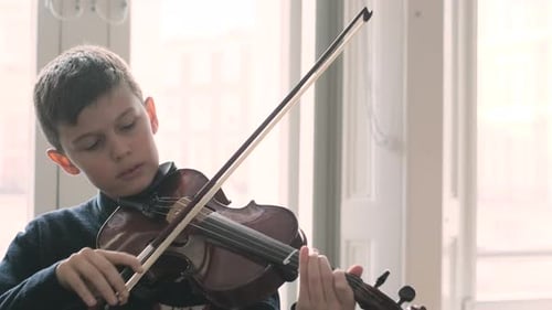 Boy Plays Violin Indoors Near Window