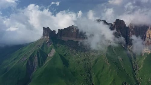 Lush Green Mountains Under Cloudy Skies Aerial