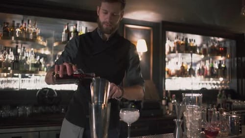 Man Prepares Cocktail at Urban Bar