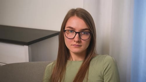 Portrait of Young Attractive Woman in Glasses Looking at Camera Serious Successful Beautiful at Home