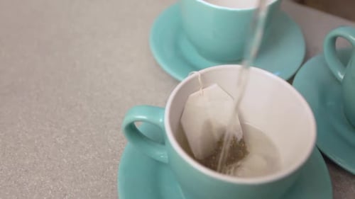 Pouring Hot Water for Tea in Ceramic Mug