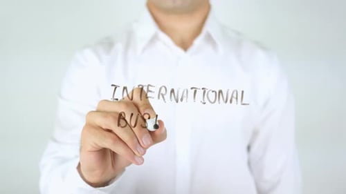 Man Writing International Business on Glass