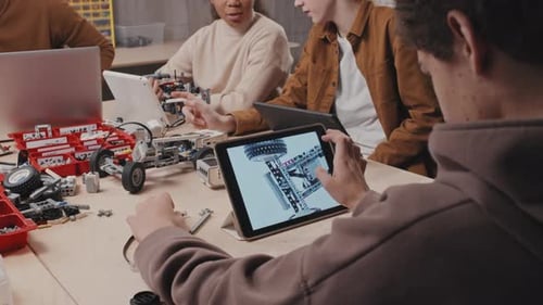 Student Watching Picture Of Robotic Model