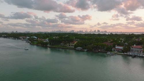 Forwards Fly Above Water Surface and Residential Borough