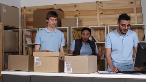 Three Multiethnic Post Office Workers Processing Parcels