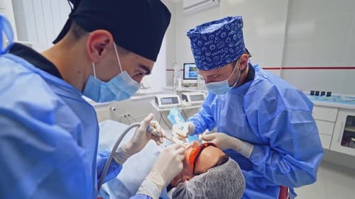 Medical Professionals Performing Procedure in Clean Clinic