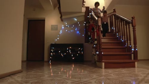 Happy Boys Running Down Staircase.