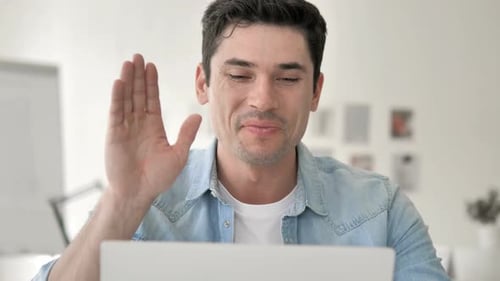 Enthusiastic Young Adult On Video Call In Bright Office