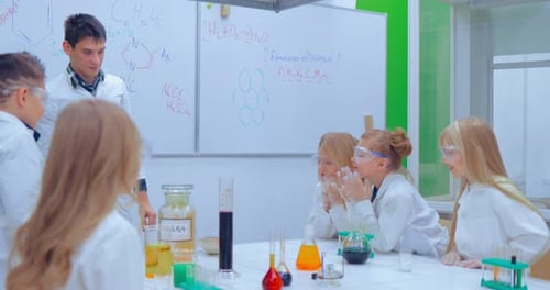 Children Studing Chemistry in School Laboratory