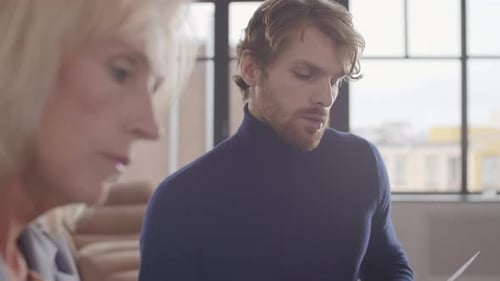 Business Colleagues Discussing Documents in Modern Office