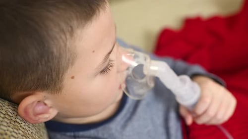 Child Uses Nebulizer Mask for Respiratory Treatment
