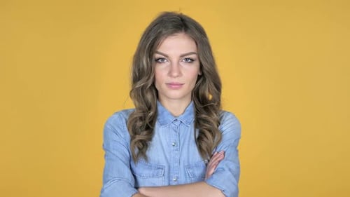 Confident Young Woman Posing Against Yellow Backdrop