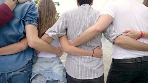 Confident group of friends standing in a row in city