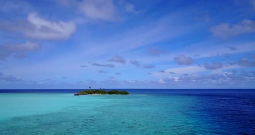 Wide angle flying abstract shot of a white paradise beach and turquoise sea background in 4K
