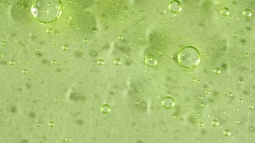 Light Green Liquid with Floating Bubbles Macro Close Up