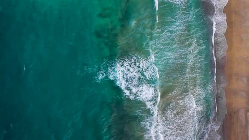 Aerial View of the Mediterranean Coast Waves Reach the Deserted Sandy Beach