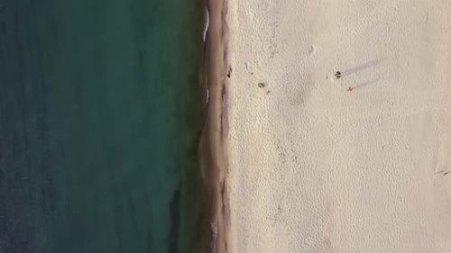 Top View of Sand Beach and Blue Sea Filmed By the Drone Flying Alone Coastline